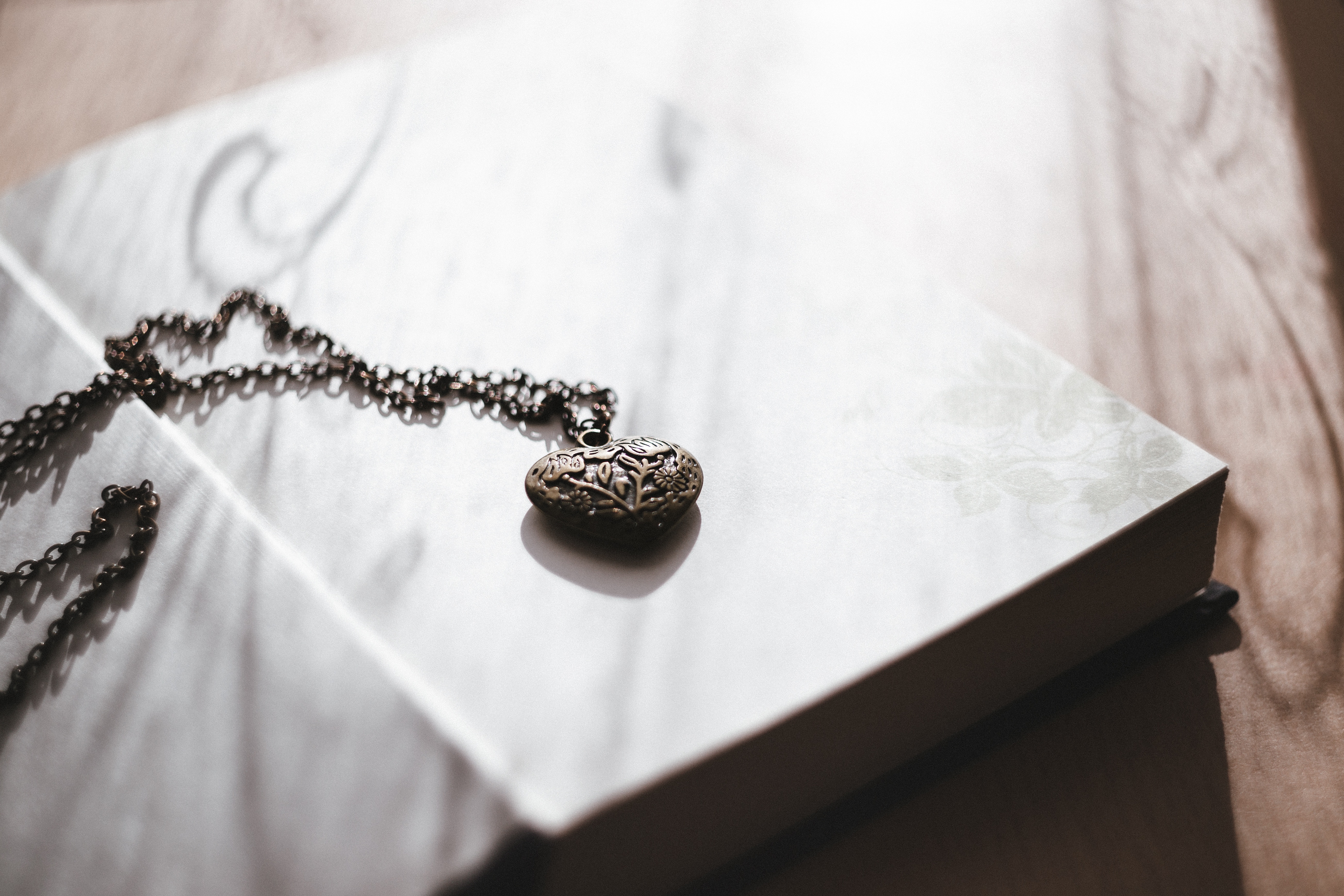 Image of a locket necklace on a book
